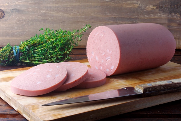 piece of whole raw pork mortadella on cutting board with some slices italian food 1 - Горячие бутерброды