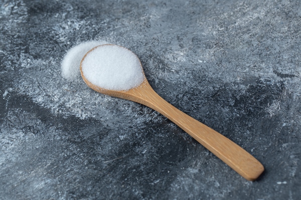 salt in a wooden spoon on a marble background - Кофе с сахаром и солью в турке