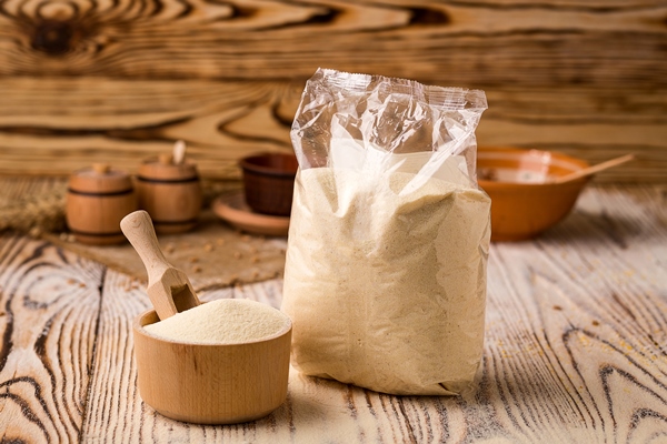 semolina in packing and bowl on a wooden background healthy dietary cereals concept - Бульон с манной крупой