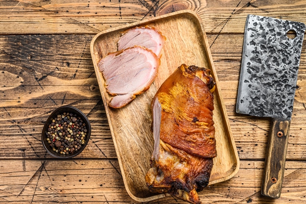 sliced baked pork leg on a cutting board - Гороховый суп с копчёностями