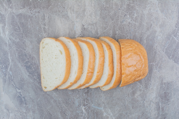 sliced of fresh bread on marble background - Горячие бутерброды