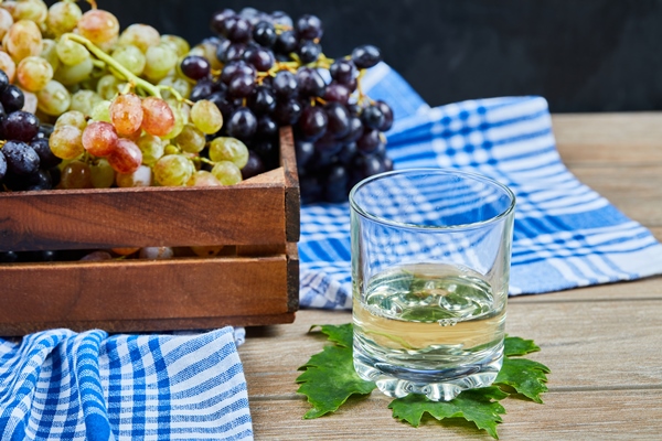 a glass of white wone on wooden table with grapes - Соус "Южный"