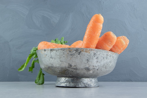 a stack of carrots in the bowl on the marble background - Сельдь под шубой