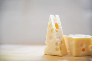 beautiful cheeses in the kitchen cheese food preparing concept - Молочный суп с лососем и рисом