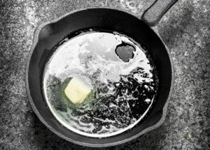 butter in an old pan on rustic background - Сырный суп с копчёностями и молоком