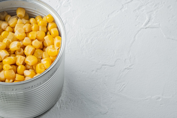 canned sweet corn in can on white background with copy space for - Салат из крабовых палочек с рисом