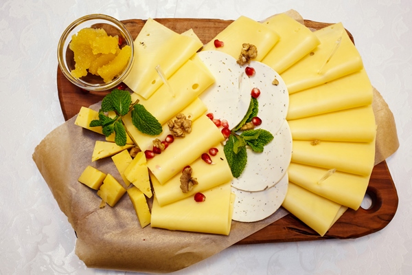 cheese plate with variety of appetizers on table on event catering - Правила подачи сыров