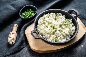 cottage cheese in a cast iron bowl with herbs - Творог с молодой зеленью