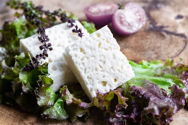 feta goat cheese with green salad on rustic wooden - Клёцки из брынзы