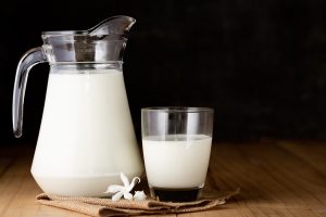milk glass jug wooden table - Молочный суп с тыквой и рисом