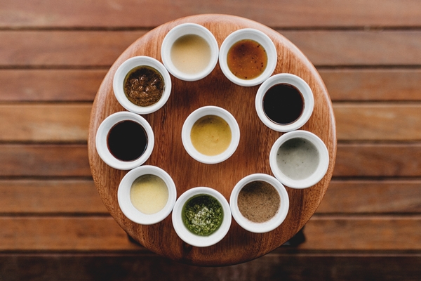 overhead shot ten white bowls with different sauces spices them aligned stool - Правила приготовления салатов