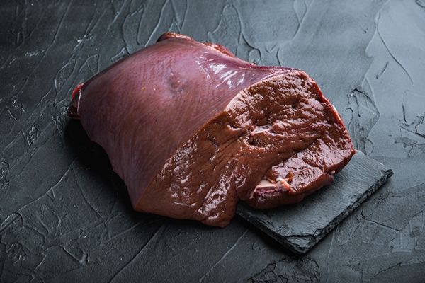 raw beef liver on black background - Паштет из печени