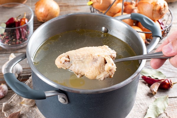 saucepan with chicken bouillon or bone broth on the wooden table paleo diet - Куриный суп с кукурузой и сыром