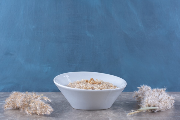 a white bowl with tasty healthy oatmeal porridge for breakfast - Монастырская кухня: овсяная каша, закуска из баклажанов (видео)