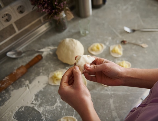 a woman sculpts dumplings in the kitchen portrait of hands - Монастырская кухня: кабачки с тофу, картофельные вареники с грибами, кукуруза с мёдом (видео)