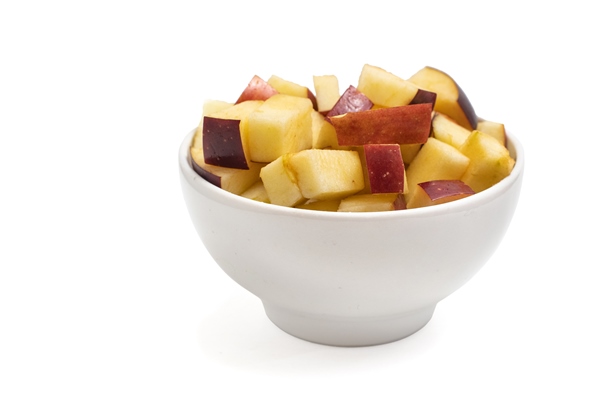 apple slices in bowl isolated on white background side view - Монастырская кухня: перловка с квашеной капустой и яблочный рулет