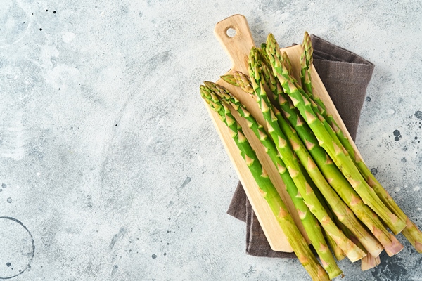 asparagus fresh green asparagus bunch ready for cooking on white old wooden background top view copy space - Монастырская кухня: мидии в белом вине, салат из авокадо со спаржей и креветками