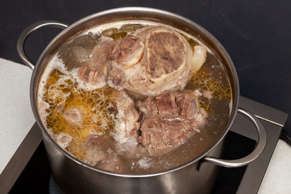 beef bone broth is cooked in a pot top view bones contain collagen - Ножки свиные или телячьи жареные