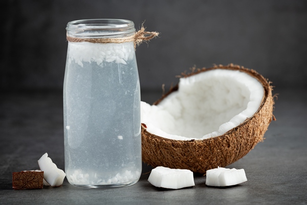 bottle of coconut water put on dark background - Кокосовый урбеч