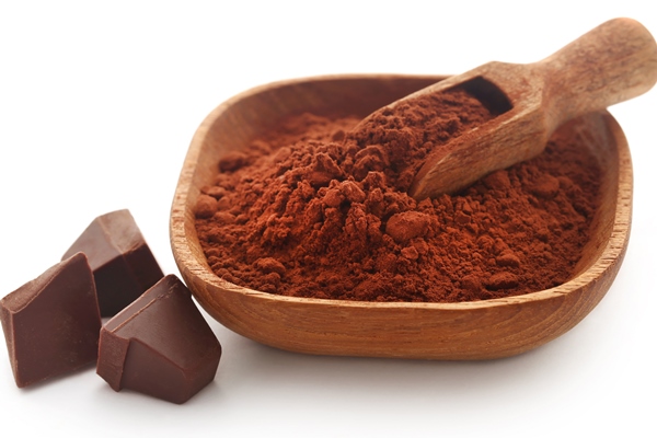 cacao powder with dark chocolate over white background - Арахисовая паста с миндалём