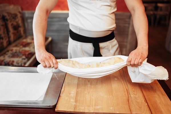 chef prepares classical apple strudel top view - Кулебяка из дрожжевого теста