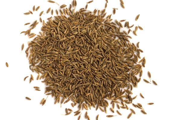 close up pile of cumin or zira seeds isolated - Хумус с авокадо