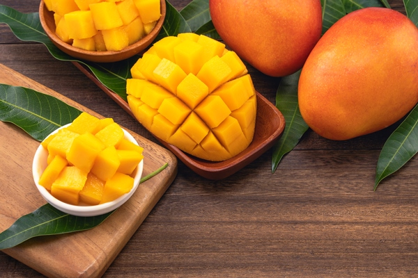 fresh chopped mango cubes on wooden cutting board and rustic timber background tropical summer fruit concept close up macro copy space 1 - Гречнево-кокосовая каша без варки
