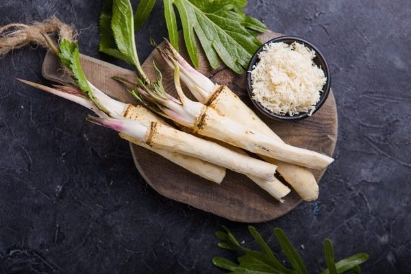 fresh orgaanic horseradish or horse radish root on wooden cutting board rotated e1686742003649 - Соус с хреном для отварного языка и мяса