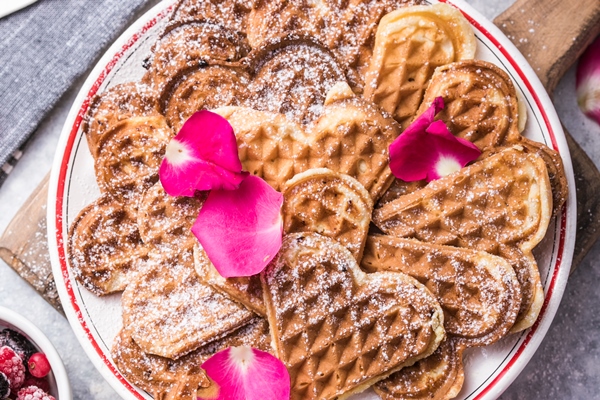 freshly baked homemade heart shaped belgium waffles on gray background european baked pastry sweets - Монастырская кухня: маково-ореховые вафли