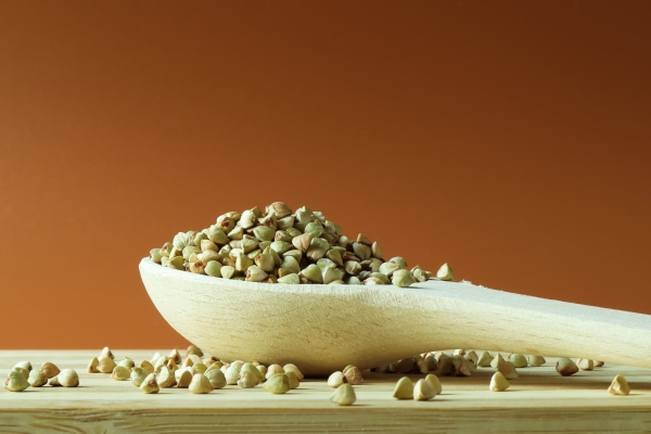 green buckwheat in a wooden spoon on a brown space great food healthy groats - Постный огуречный суп без варки