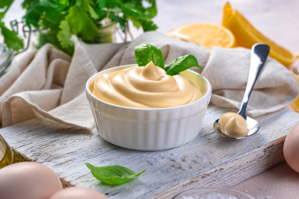 mayonnaise and natural ingredients on a light background - Соус майонез