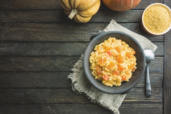 millet porridge with sweet pumpkin in a bowl rustic style healthy vegan dish top view - Монастырская кухня: тыковник с черносливом и постные оладьи