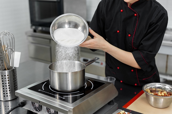 pastry chef pours the sugar into a saucepan 1 - Монастырская кухня: драники, постные шоколадные пряники