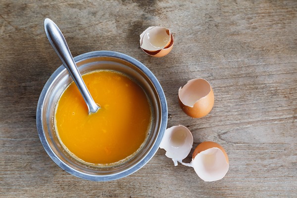 raw eggs stirred in a bowl for cooking - Кулич (пасха) казацкий старинный