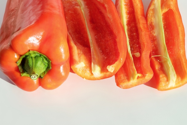 red bell pepper with cut slices on light surface close up - Лапша с поджаркой из овощей и сейтана (клейковины)