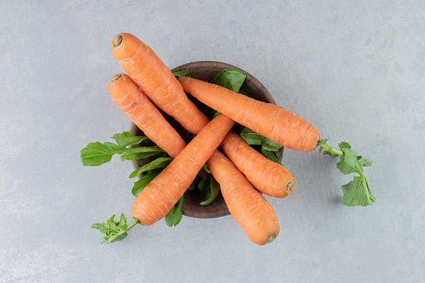 ripe carrots in the bowl on the marble - Монастырская кухня: суп из зелени и чинёная репа