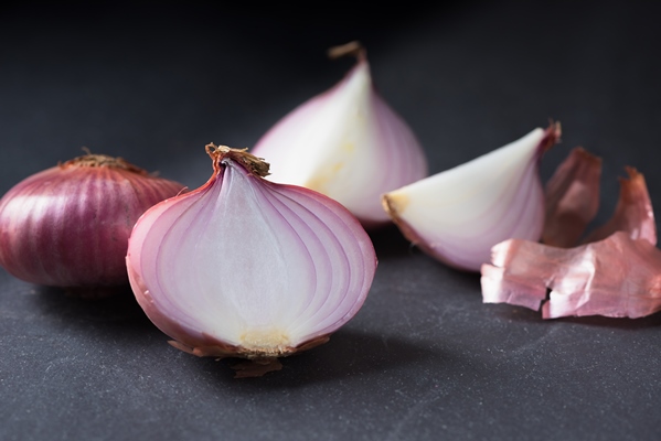 sliced red onions on black stone background vegetable for cooking food - Монастырская кухня: калья и ягодный десерт