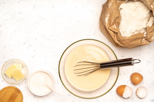 the process of making dough for pancakes with ingredients on a light table eggs and flour are whipped with a mixer 3 - Разноцветные блинчики