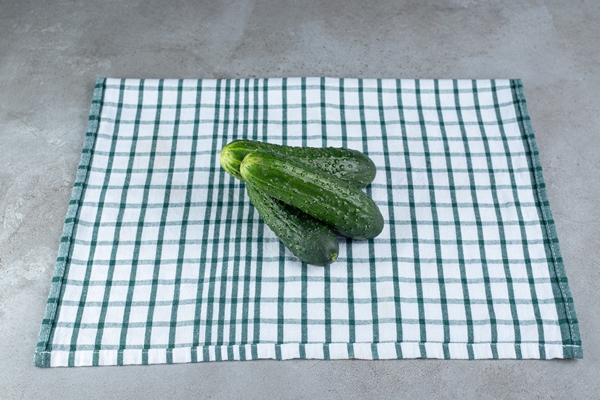 three fresh cucumbers isolated on a tablecloth high quality photo - Суп постный из авокадо и огурцов без варки