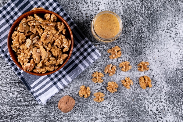 top view walnuts in bowl and nuts butter on stone horizontal 1 - Урбеч из грецких орехов закусочный