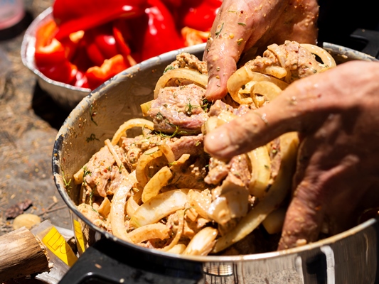 unrecognizable cook mixing pieces of meat and onion for shashlik - Шашлыки