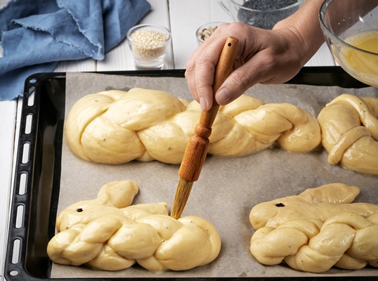 brushing with butter buns before baking - Булочки "Пасхальные зайцы"
