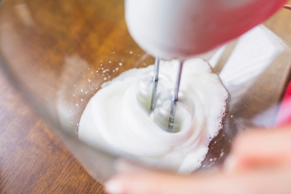 crop person mixing ingredients with - Суфле манное на молоке, паровое