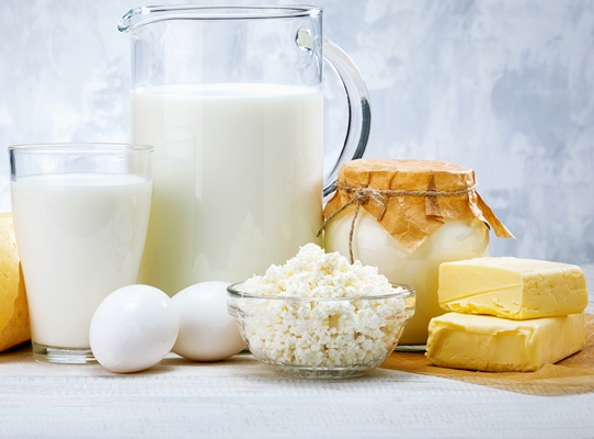 fresh dairy products milk cheese eggs yogurt sour cream and butter on white wooden table - Яблоки, фаршированные творогом и изюмом