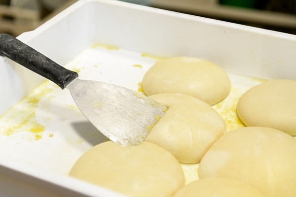 fresh dough balls made for cooking pizza in the white plastic box in a pizzeria - Пасхальный хлеб по-испански