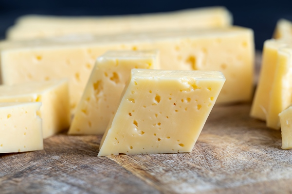 fresh yellow milk cheese on a board - Особенности питания детей