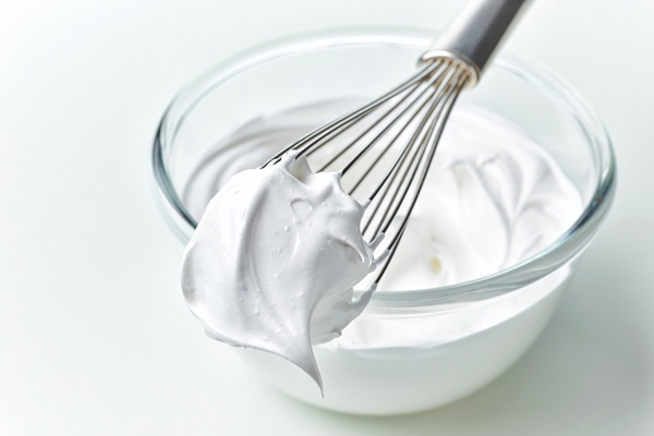 glass bowl of whipped egg whites cream on white kitchen table background - Кулич "Пасхальный голубь"