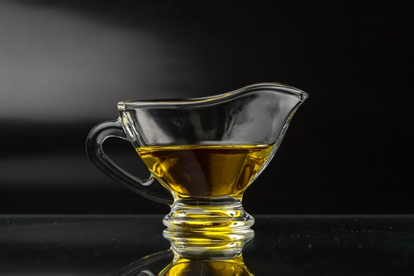 olive oil in a glass gravy boat on a black surface - Анисовые сухарики «Пестиньос» (Pestiños)