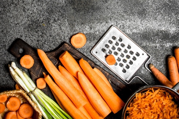 organic fresh carrots on the rustic table - Оладьи из икры с луком и морковью