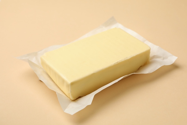 paper with butter on beige background close up - Лечебный стол (диета) № 3 по Певзнеру: таблица продуктов и режим питания